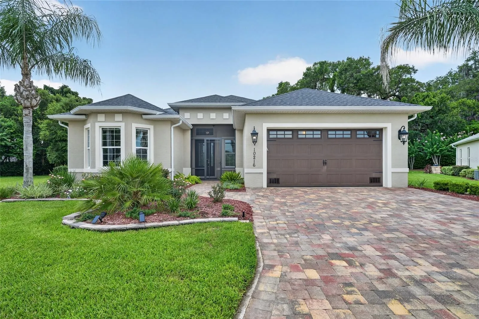 10216 Julia Isles Avenue, Oxford, with a paver driveway and front landscaping