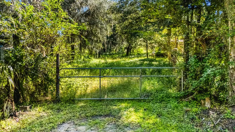Gate and wooded entrance to 1707 Kimmie Kay Drive