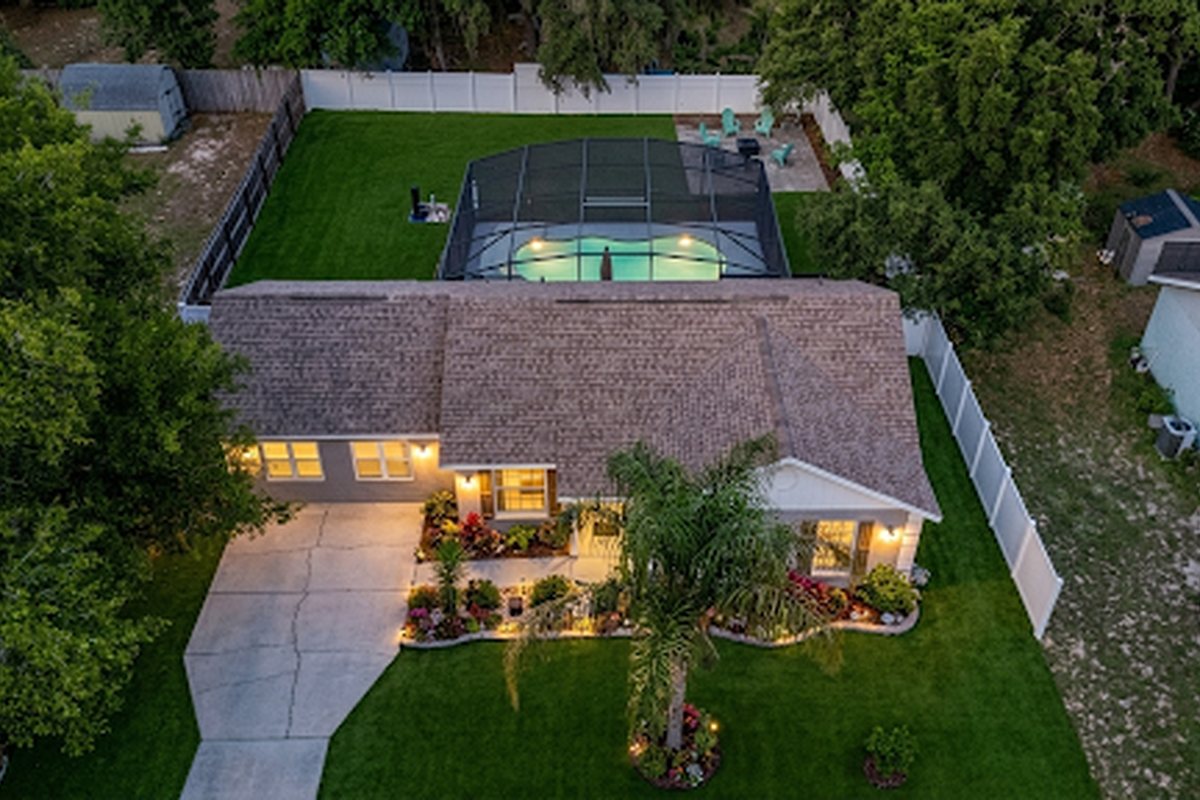 40140 Palm St, Lady Lake - aerial twilight view with screened pool