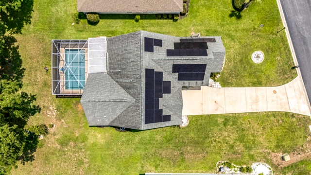 Aerial view of the rear of the home and screened pool